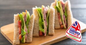 a trio of delicious freshly made sandwiches on a wooden board